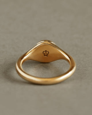 Solid 18k yellow gold band with soft button circle atop elegant signet style ring