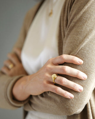 Large 18k yellow solid gold signet style ring with a large soft concave button circle atop the signet.