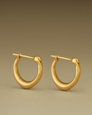 Pair of solid 18k yellow gold hoop earrings with a soft dome shape. Part of the George Rings Capitol Collection.