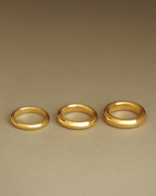 Comparison of three Dominus Bands side-by-side - original, mid, and grand. Donut band cast in solid 18k yellow gold. Not hollow. Classic wedding band.
