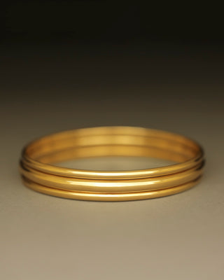 Solid 18k yellow gold round bangle by George Rings. Dominus Bangle. Not hollow.