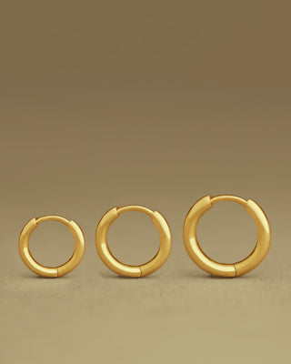 comparison of three sizes of dominus hoops by george rings in solid 18k yellow gold - size small medium and large