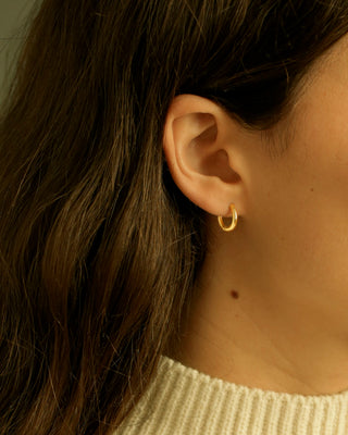 dominus hoops by george rings on model in solid 18k yellow gold - size large