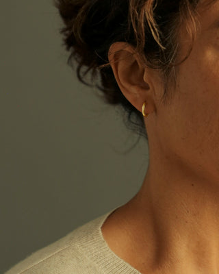 dominus hoops by george rings on model in solid 18k yellow gold - size medium