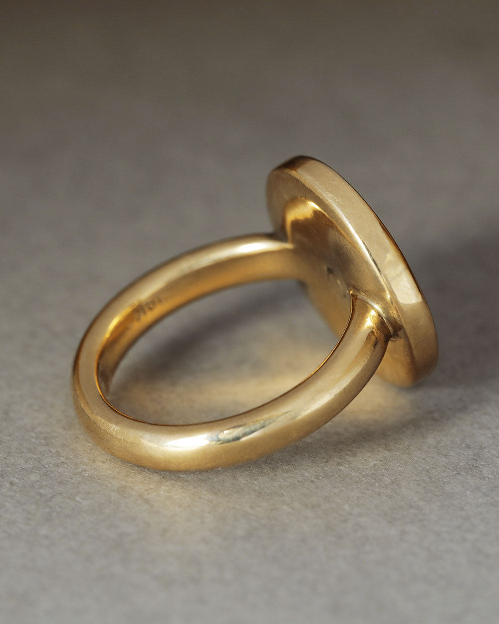 solid 18k yellow gold Dutch Coin ring. Large circle of gold with a slight puff in the center and softened, thick edges. 
