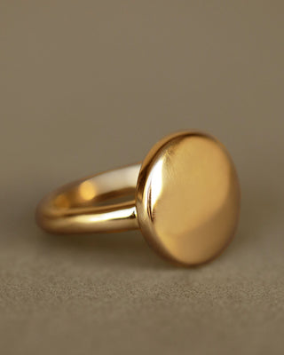 solid 18k yellow gold Dutch Coin ring. Large circle of gold with a slight puff in the center and softened, thick edges. 