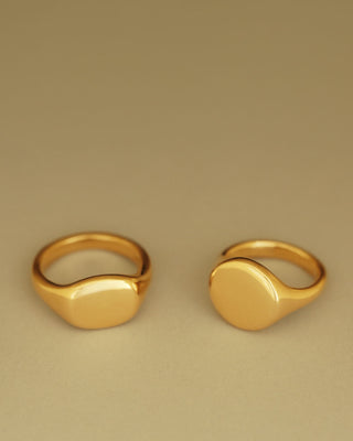 Solid 18k yellow gold heavy signet ring. Hugo Signet Ring by George Rings next to Florentine Signet Ring.