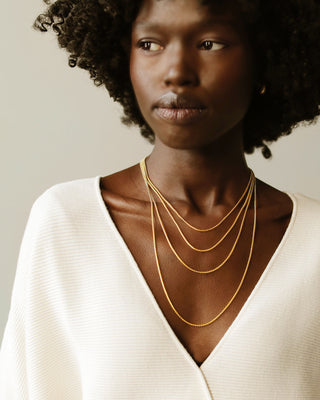 Three solid gold box chains by George Rings 14k yellow gold in sizes 16" 18" 20" 24" with a lobster clasp.