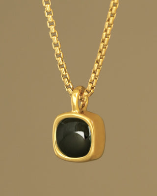 A moody black green tourmaline rounded square gem inside a solid 18k yellow gold bezel. Sovereign Pendant by George Rings.