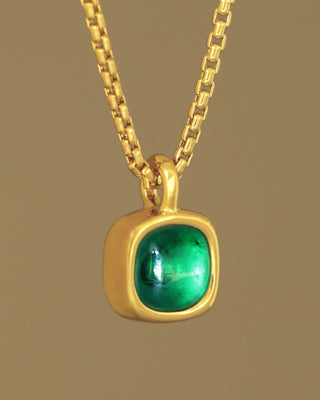 A juicy green lab grown emerald rounded square gem inside a solid 18k yellow gold bezel, hanging on a solid 14k yellow gold box chain. Sovereign Pendant by George Rings.