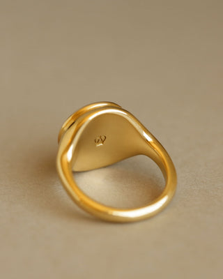 Golden large round cabochon citrine gem sits inside large round 18k solid yellow gold signet ring. The Monarch by George Rings.