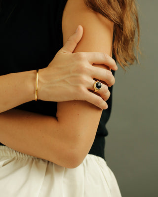 Large, round cabochon solitaire ring cast in solid 18k yellow gold. The Monarch in black onyx by George Rings.